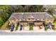 Aerial view of townhomes featuring well-maintained driveways, landscaping and yellow trim at 8421 Pine River Rd, Tampa, FL 33637