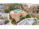 Aerial view showcasing a community pool, clubhouse, landscaping, parking, and surrounding trees at 8421 Pine River Rd, Tampa, FL 33637