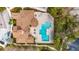 Aerial top-down view of community pool, amenity center, deck chairs and landscaping at 8421 Pine River Rd, Tampa, FL 33637