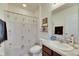 Bathroom with a bathtub and shower, toilet, and vanity with ample storage at 8421 Pine River Rd, Tampa, FL 33637