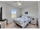 Bright bedroom featuring a comfortable bed with stylish bedding and a window providing natural light at 8421 Pine River Rd, Tampa, FL 33637