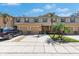 Inviting townhome exterior featuring a well-manicured lawn, a garage, and beautiful landscaping at 8421 Pine River Rd, Tampa, FL 33637