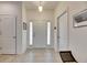 Bright and airy foyer with tile flooring, a front door with sidelights, and neutral decor at 8421 Pine River Rd, Tampa, FL 33637