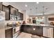 Contemporary kitchen with stainless steel appliances, ample counter space, and a view to the living area at 8421 Pine River Rd, Tampa, FL 33637