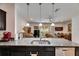 Kitchen with granite countertops, stainless steel sink, and view to the living and dining room at 8421 Pine River Rd, Tampa, FL 33637