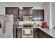 Kitchen features granite countertops, stainless steel appliances and dark brown cabinets at 8421 Pine River Rd, Tampa, FL 33637