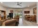 Cozy living room and dining area with tile floors, a ceiling fan, and a sliding glass door to the patio at 8421 Pine River Rd, Tampa, FL 33637