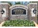 Community sign featuring stonework, elegant lighting, and the words 'Hidden River' at 8421 Pine River Rd, Tampa, FL 33637