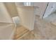 Carpeted stairway featuring tan carpet, white walls and trim at 8421 Pine River Rd, Tampa, FL 33637