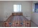 Bedroom featuring a patterned bedspread, white nightstands, and natural light from two windows at 8525 111Th St # 210, Seminole, FL 33772