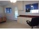 Bright bedroom with a built-in desk, natural light, and outside access at 8525 111Th St # 210, Seminole, FL 33772