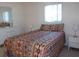 Comfortable bedroom featuring a patterned bedspread, white nightstands, and natural light at 8525 111Th St # 210, Seminole, FL 33772