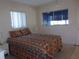 Bedroom with a patterned bedspread and white nightstands, offering a calm and inviting space at 8525 111Th St # 210, Seminole, FL 33772