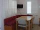 Bright breakfast nook with built-in seating, plantation shutters, and a wooden table at 8525 111Th St # 210, Seminole, FL 33772