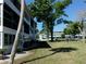 View of the exterior, surrounded by green space and mature trees at 8525 111Th St # 210, Seminole, FL 33772