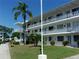 Exterior view of a condo complex, showcasing a bright white facade and well-kept landscaping at 8525 111Th St # 210, Seminole, FL 33772