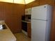 Functional kitchen with stainless steel sink, ample wood cabinets, and white appliances at 8525 111Th St # 210, Seminole, FL 33772
