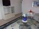 The living room features a glass coffee table and tile floors, with a blue accent rug at 8525 111Th St # 210, Seminole, FL 33772