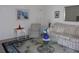 Bright living room featuring a blue accent rug and an ornate glass table and furniture at 8525 111Th St # 210, Seminole, FL 33772