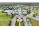 An aerial view of Club Connerton with its pools, tennis courts, water park, roads, and well-manicured landscaping at 8887 Little Bluestem Dr, Land O Lakes, FL 34637