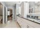 Bathroom with granite countertops, double sinks and access to the bedroom at 8887 Little Bluestem Dr, Land O Lakes, FL 34637