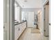 Bright bathroom featuring tile flooring, white cabinets, and a shower at 8887 Little Bluestem Dr, Land O Lakes, FL 34637