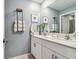 Bathroom featuring a double vanity, modern fixtures, and stylish decor at 8887 Little Bluestem Dr, Land O Lakes, FL 34637