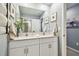 Bathroom with double vanity, framed mirrors, and towel racks for a spa-like feel at 8887 Little Bluestem Dr, Land O Lakes, FL 34637
