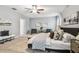 Cozy bedroom with natural lighting, a ceiling fan, and an upholstered bench at the end of the bed at 8887 Little Bluestem Dr, Land O Lakes, FL 34637