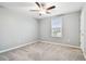 Bright bedroom features plush carpeting, a ceiling fan, and a window with blinds at 8887 Little Bluestem Dr, Land O Lakes, FL 34637