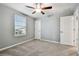 Bedroom with carpet flooring, ceiling fan, natural light, and white doors at 8887 Little Bluestem Dr, Land O Lakes, FL 34637