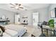 Spacious bedroom with access to the en suite bathroom and view to the kitchen at 8887 Little Bluestem Dr, Land O Lakes, FL 34637