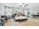 Bedroom featuring a ceiling fan, neutral colored walls, a desk with chair and bench at foot of bed at 8887 Little Bluestem Dr, Land O Lakes, FL 34637