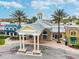 Club Connerton featuring a grand entrance with columns, a tin roof, and space for Corner Town Cafe guests at 8887 Little Bluestem Dr, Land O Lakes, FL 34637