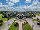 Aerial view showcasing the community center's amenities and lush, landscaped grounds with water feature at 8887 Little Bluestem Dr, Land O Lakes, FL 34637