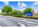 Welcome to Connerton! A beautiful community entrance with mature landscaping, a brick pillar, and a signature blue sign at 8887 Little Bluestem Dr, Land O Lakes, FL 34637