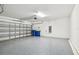 Spacious garage with epoxy flooring, and a garage door at 8887 Little Bluestem Dr, Land O Lakes, FL 34637