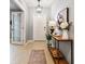 Welcoming foyer featuring a console table, stylish lighting, and wood-look tile flooring at 8887 Little Bluestem Dr, Land O Lakes, FL 34637