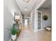 Inviting entryway with light tile floors and neutral walls leading into the open living space at 8887 Little Bluestem Dr, Land O Lakes, FL 34637