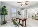 Bright home office with a desk, comfortable chair, and plenty of natural light at 8887 Little Bluestem Dr, Land O Lakes, FL 34637