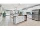Spacious kitchen with granite island, stainless steel appliances, and open to the living area at 8887 Little Bluestem Dr, Land O Lakes, FL 34637