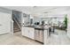 Granite kitchen island with stainless steel appliances, cabinetry, and an open view to living room at 8887 Little Bluestem Dr, Land O Lakes, FL 34637