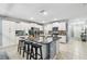 Spacious kitchen features white cabinets, stainless steel appliances, granite countertops, and center island with seating at 8887 Little Bluestem Dr, Land O Lakes, FL 34637