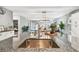Granite kitchen island sink with modern faucet, open to the living room and outdoor pool at 8887 Little Bluestem Dr, Land O Lakes, FL 34637