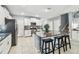 Bright kitchen features white cabinets, stainless steel appliances, granite countertops, and center island with seating at 8887 Little Bluestem Dr, Land O Lakes, FL 34637