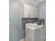 Functional laundry room featuring modern washer/dryer and ample storage cabinets overhead at 8887 Little Bluestem Dr, Land O Lakes, FL 34637