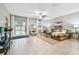 Spacious living room features a comfortable sectional, stylish decor, and access to the backyard at 8887 Little Bluestem Dr, Land O Lakes, FL 34637