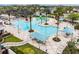 Resort-style community pool with palm trees, splashpad and covered seating areas at 8887 Little Bluestem Dr, Land O Lakes, FL 34637