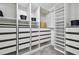Spacious walk-in closet with ample shelving, drawers, and hanging rods offers lots of storage at 8887 Little Bluestem Dr, Land O Lakes, FL 34637