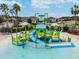 Connerton Water Park featuring a kid-friendly water jungle gym with slides, climbing areas, and splash zones at 8887 Little Bluestem Dr, Land O Lakes, FL 34637